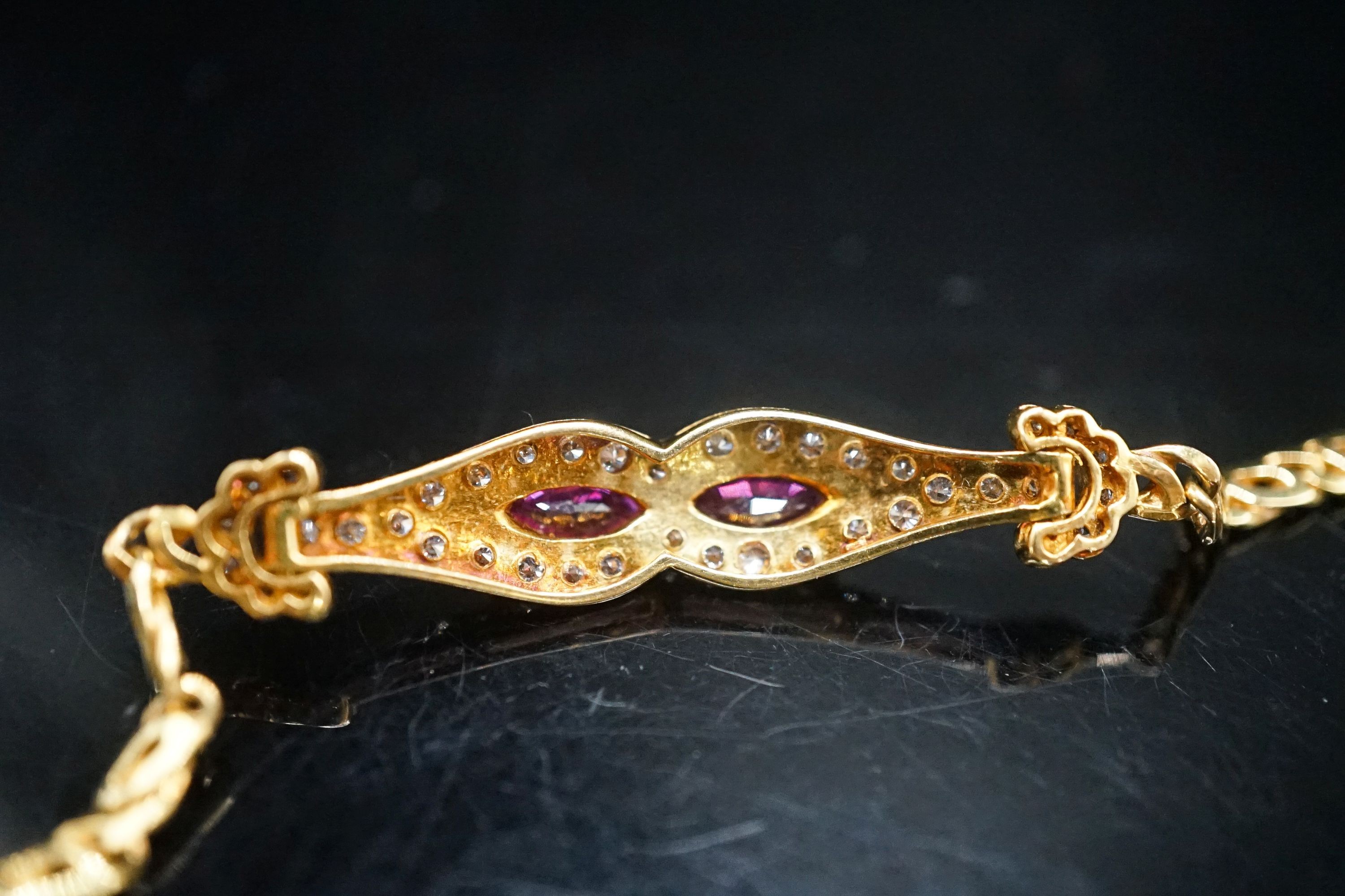 A lady's modern 18k, ruby and diamond set bracelet, 16cm, gross weight 9.2 grams.